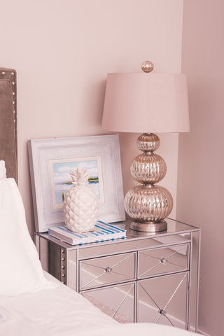 Bedroom with pink wall and pink lamp