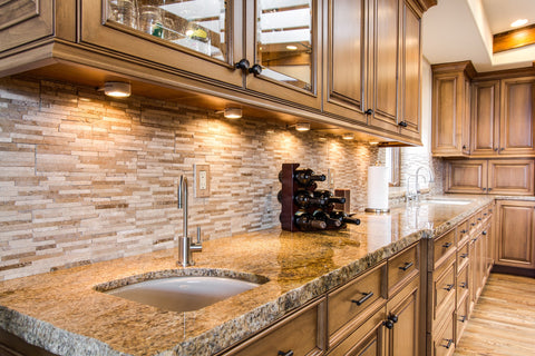 Kitchen with natural stone counter and backsplash