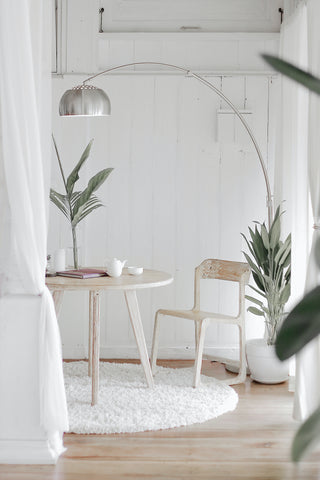 Room with white wales and pale wood flooring