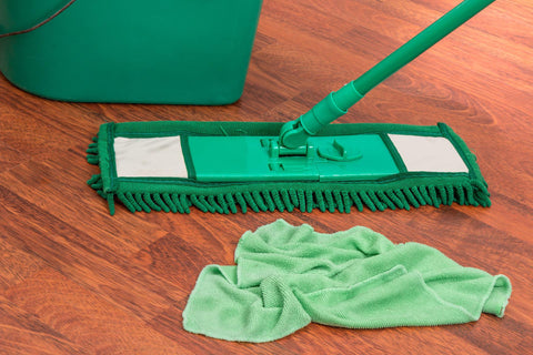 Dust mop and cloth on floor