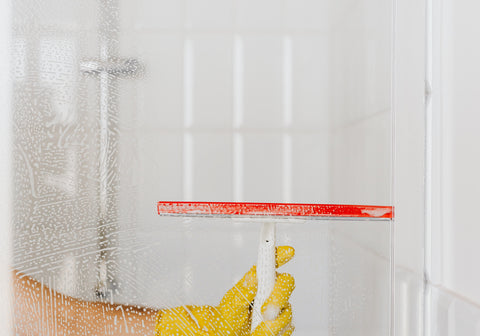 Person cleaning shower